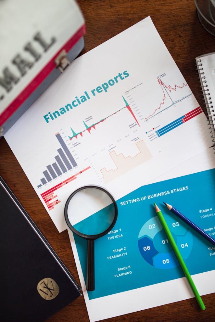 pexels-photo-7947657 Financial report with charts and graphs analyzed with a magnifying glass.
